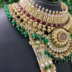 A close-up of the multi-strand pearl and beaded chains connecting the choker and rani haar, highlighting the rich texture and craftsmanship.