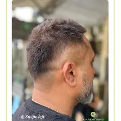 This clean, classic men's haircut features a subtle fade that tapers neatly at the neckline, offering a sharp and professional finish.
