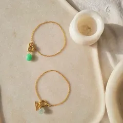 A close-up of the melon toggle bracelets, showing the unique cut of the stones.