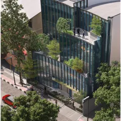 An aerial view of a proposed commercial building in Koramangala, with a playful, curved glass facade that creates a series of stepped terraces. These outdoor spaces are designed as green extensions of the indoor offices.
