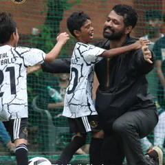 The bond between a coach and a player after a moment of success on the field. We are more than an academy; we are a family that supports and celebrates each other's growth and achievements.