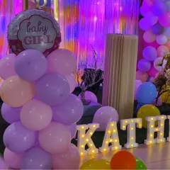 A close-up of the 'Welcome Baby' decor, showing the 'Baby Girl' foil balloon and personalized marquee letters. These details make the celebration extra special for the new parents.