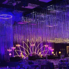 The combination of the shimmering crystal curtains and the glowing neon stage created a truly immersive experience, making guests feel as though they were celebrating under a starry night sky.