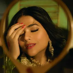 A reflective moment from the 'Prem Patra' photoshoot. This close-up, seen through a mirror, highlights the classic winged eyeliner and soft, romantic makeup that defined this retro-themed series.