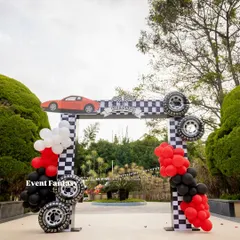 The grand entrance arch for Krianshh's Ferrari World. The arch is decorated with checkered patterns, real tires, and a sleek red sports car cutout on top.