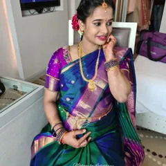 A beautiful client ready for her baby shower function. Her makeup is radiant, paired with a traditional silk saree and a floral hairstyle.