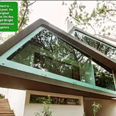 A detail of the Mobius Home's cantilevered glass structure. This element creates a feeling of being suspended amongst the trees, blurring the line between the interior and the lush exterior environment.