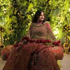This is one of my most elegant floral dupattas, featuring a dense border of red rose petals. It creates a dramatic and royal look, perfect for a bride on her wedding day.