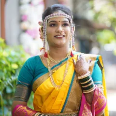 A happy bride showcasing her complete look. The makeup is complemented by a traditional mundavalya and a radiant smile, ready for her big day.