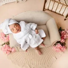Can you believe she is just 10 days old? This little darling rocked every pose like a boss, especially in this adorable spa day setup with a tiny bathrobe and floral accents.