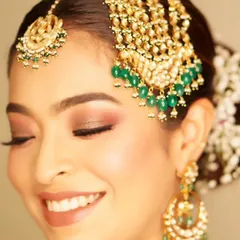 A classic smokey eye with a touch of glitter is always a stunning choice. This look, created for the groom's sister, is radiant, glamorous, and perfect for a wedding celebration.