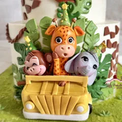 Look at these party animals! A close-up of the cheeky monkey, giraffe, and elephant peeking out of their safari jeep.