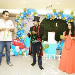 Here I am teaching a couple the basics of the linking rings trick at a birthday party. It's a great icebreaker and gets everyone involved in the fun.