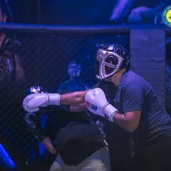 Two fighters spar inside the cage, showcasing the importance of match experience. I believe training should include real-time scenarios to build confidence and tactical skills.