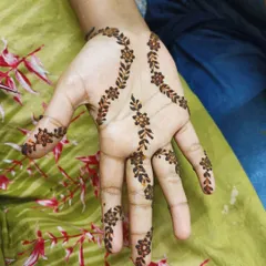 A delicate floral vine pattern that gracefully adorns the palm and fingers. This type of minimalist mehendi is perfect for someone trying henna for the first time or for young guests at a party.