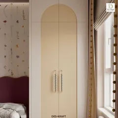 A detail of the arched wardrobe doors with unique beaded handles, adding a touch of bespoke charm to the room's soft and pastel aesthetic.