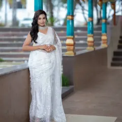 A full-length portrait from a student's portfolio, showcasing a modern white saree look.