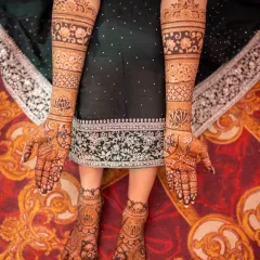 Complete bridal elegance from hands to feet. This photo showcases a cohesive design with lotus motifs and geometric patterns that flow beautifully across the arms and legs.