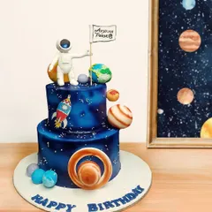 3, 2, 1, blast off! This space-themed cake is perfect for a little astronaut's birthday. It features a two-tier galaxy design, edible planets, a rocket ship, and an astronaut planting a personalized flag.