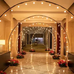 Less is more with this elegant and classy Sangeet entrance. A series of arches with warm bulb lighting created an enchanting tunnel effect, proving that simple, well-executed ideas can be utterly stunning.