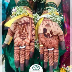 The beautiful, dark stain of a baby shower mehendi. This design features a mother cradling her baby and a traditional cradle, symbolizing the love and anticipation for the new arrival.