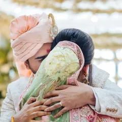 An intimate, close-up shot of the couple hugging tightly after their wedding ceremony, a moment of pure emotion.