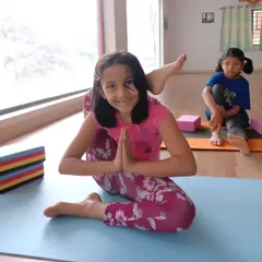 Look at that smile. This young yogi is mastering Eka Pada Sirsasana, or the leg-behind-head pose, with confidence. My goal is to help every child feel proud of their progress, no matter the pose.