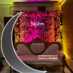 For an elegant and dramatic baby shower backdrop, I created this full flower wall with a 'Baby Shower' neon sign. The large, illuminated crescent moon prop in the foreground adds a beautiful touch for photos.