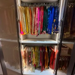 A rainbow of color in this festive wear closet. We organize by color and occasion, hanging delicate items to maintain their shape and beauty. The integrated lighting makes selecting the perfect outfit a delight.