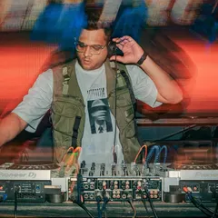 A motion blur shot of me at the decks, showcasing the fast paced and dynamic nature of my mixing style.