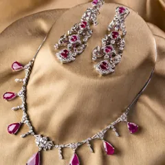 Introducing the Scarlet Royale set, a tribute to old-money charm with a modern sensibility. This ruby and diamond necklace with matching earrings is for the bride who wants presence without the weight, featuring rose-cut diamonds and deep red oval rubies.