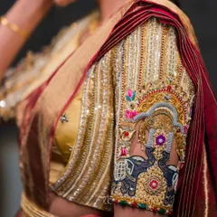 A close-up of the sleeve embroidery, showcasing the majestic elephant motif crafted with zardosi and threadwork. Each detail is meticulously placed to create a piece of wearable art.