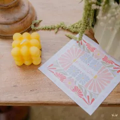 A custom-designed coaster with the event's floral motif and hashtag, paired with a fun bubble candle, making for a beautiful and memorable guest favor.