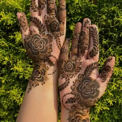An example of a modern, bold floral design. This style uses negative space to make the dark henna pop, perfect for someone who wants a statement look that isn't as dense as traditional bridal mehendi.