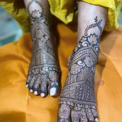 An intricate design for the bride's feet, featuring a combination of floral and geometric patterns that extend from the ankle to the toes.