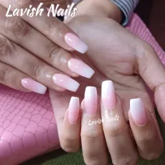 A beautiful example of a Baby Boomer or ombre nail design on medium-length coffin nails. The seamless blend from a soft pink base to a crisp white tip creates a subtle and chic look.