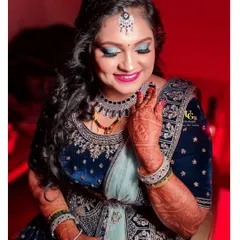 A full view of a glamorous reception lehenga look. I teach how to balance a colorful eye with the rest of the makeup and ensure it complements an ornate outfit.