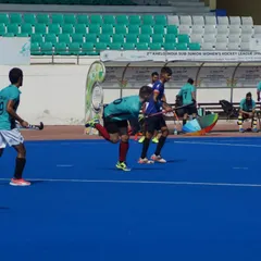 A fast-paced moment during our game on the blue AstroTurf. My players are focused on executing a penalty corner, a critical scoring opportunity.