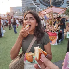 A happy customer enjoying the first bite of our Korean Cream Cheese Bun at The Lil Flea.