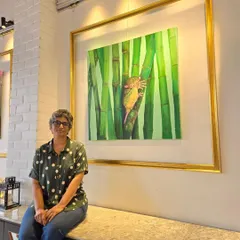 Artist Isha Valentine sits with her captivating painting of a tarsier during our Affordable Art Exhibition. We are committed to supporting prominent artists and bringing their important work to a wider audience.