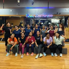 The energy in our group classes is contagious. Here's our crew feeling strong and accomplished after a great session, with our "I love Zest Fitness" sign lighting up the background.