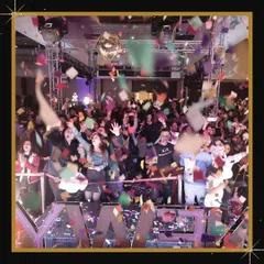 We create events where guests feel completely immersed in the celebration. This photo shows the crowd at our New Year's Eve party enjoying the music and confetti drop at the stroke of midnight.