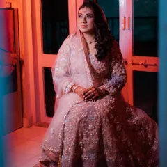 A thoughtful moment captured beautifully. This image highlights the intricate details of her Walima gown and the soft, elegant makeup that complements it perfectly.