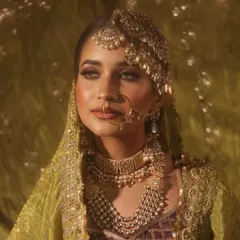 A close-up shot highlighting the intricate details of the passa and the soft, glowing makeup. The lighting creates a dreamy, ethereal effect, perfect for a memorable bridal portrait.