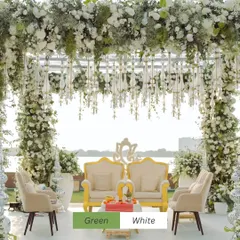 A serene green and white mandap set against a tranquil waterfront. The abundance of baby's breath and white roses created an ethereal atmosphere, perfect for a daytime wedding ceremony.