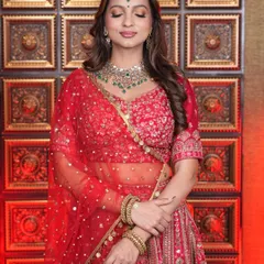 The complete look is a testament to our student's skill. They have perfectly balanced the bold red lehenga with makeup that is both glamorous and graceful.