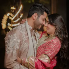 A sweet, romantic embrace under twinkling lights. This close-up shot captures the couple lost in their own world, sharing a happy, intimate moment during their evening celebration.