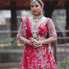 A stunning example of a layered bridal necklace set, featuring a choker and a long, multi-strand pearl rani haar that adds regal drama to the entire look.