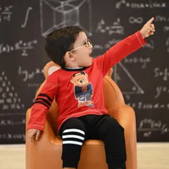 An expressive portrait of the child pointing upwards with excitement during his themed photoshoot.