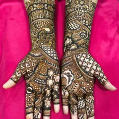 This traditional design is filled with classic elements, including parrots, paisleys, and checkerboard patterns, creating a rich and full look for the bride.